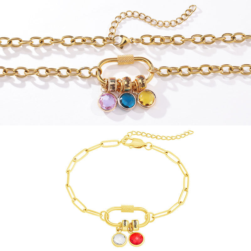 A two-part jewelry set with a pendant and a bracelet, featuring colorful gemstones and metallic clasps, displayed on a surface with pink crystals.