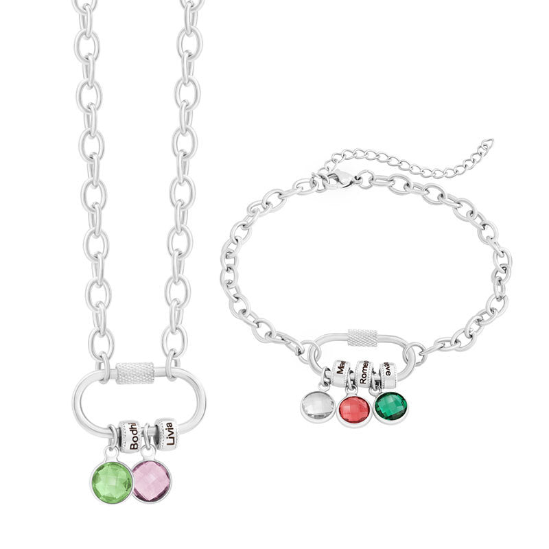 A two-part jewelry set with a pendant and a bracelet, featuring colorful gemstones and metallic clasps, displayed on a surface with pink crystals.