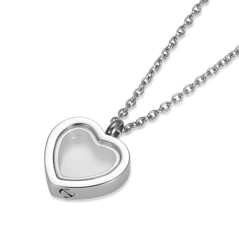 Silver heart-shaped pendant on a chain against a white background