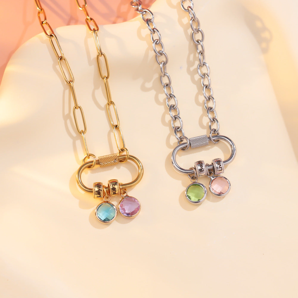 A two-part jewelry set with a pendant and a bracelet, featuring colorful gemstones and metallic clasps, displayed on a surface with pink crystals.
